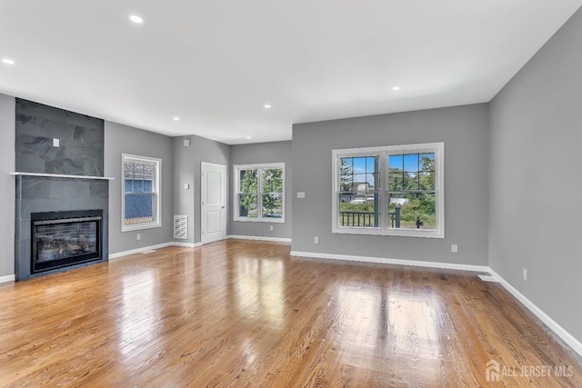 65 Bayview St, Aberdeen, NJ 07721 - unfurnished living room with recessed lighting, a large fireplace, and wood finished floors