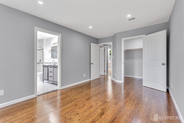 65 Bayview St, Aberdeen, NJ 07721 - unfurnished bedroom featuring wood finished floors, a closet, recessed lighting, ensuite bathroom, and a spacious closet