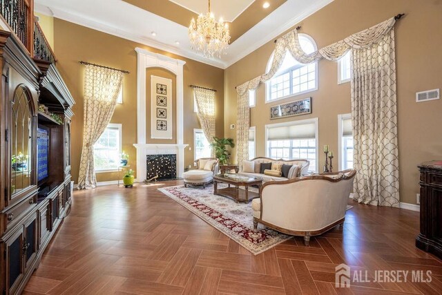 45 Imperial Ct, Monroe, NJ 08831 - living room with a high ceiling, baseboards, ornamental molding, a fireplace with flush hearth, and a chandelier