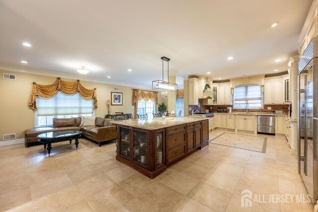 45 Imperial Ct, Monroe, NJ 08831 - kitchen featuring stainless steel dishwasher, a sink, healthy amount of natural light, light stone countertops, and ornamental molding