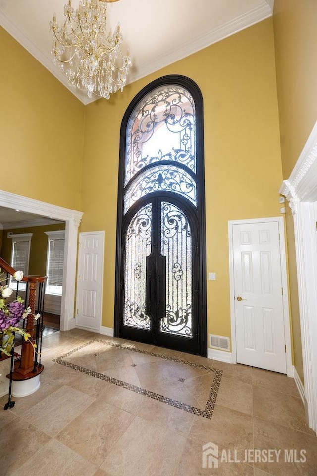 45 Imperial Ct, Monroe, NJ 08831 - entryway with a towering ceiling, french doors, baseboards, a chandelier, and crown molding
