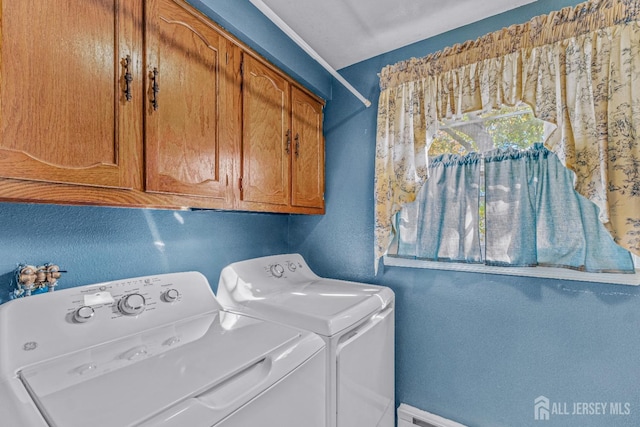 laundry area featuring separate washer and dryer, cabinet space, and baseboards