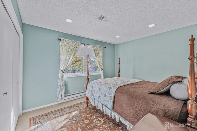 carpeted bedroom with baseboards, a textured ceiling, visible vents, and a closet