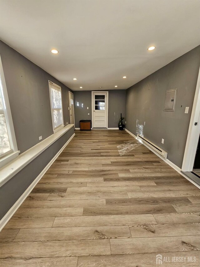 interior space featuring a baseboard radiator and light hardwood / wood-style flooring