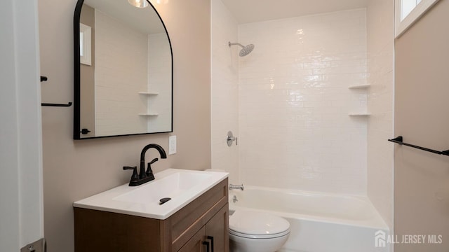 bathroom with toilet, vanity, and shower / bath combination