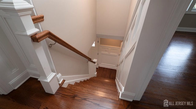 staircase with wood finished floors