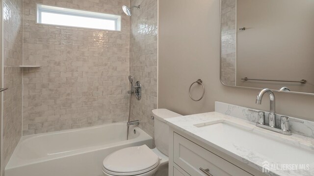 full bathroom featuring toilet, shower / tub combination, and vanity