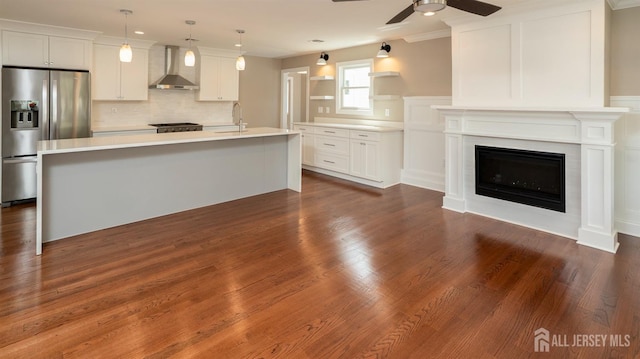 234 Rose St, Metuchen, NJ 08840 - kitchen featuring stainless steel refrigerator with ice dispenser, wall chimney exhaust hood, a ceiling fan, light countertops, and open shelves