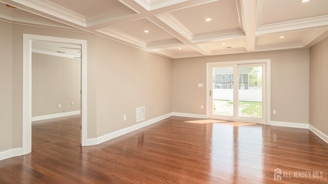 spare room with wood finished floors, beamed ceiling, coffered ceiling, baseboards, and recessed lighting