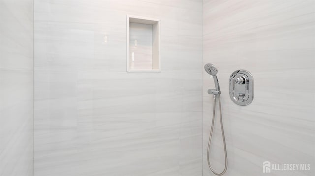 bathroom with tiled shower