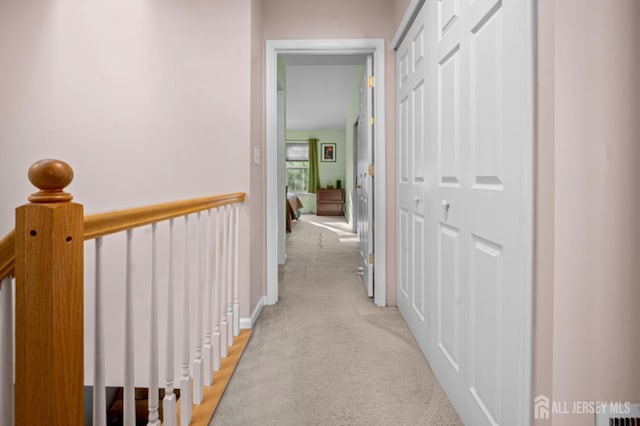corridor featuring light colored carpet