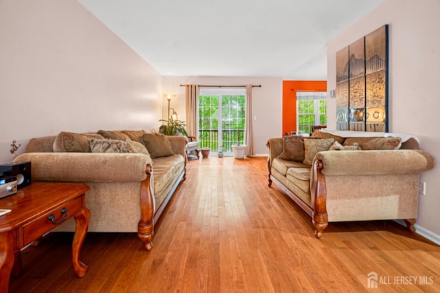 living room featuring light wood-style flooring and baseboards