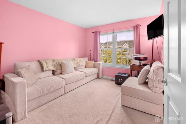 carpeted living room with baseboards