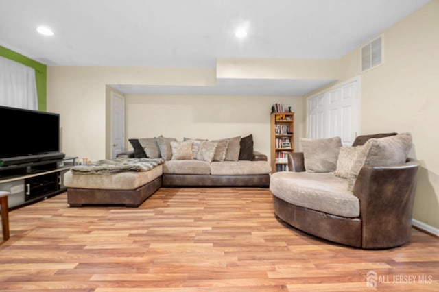 living room with light wood-style floors and recessed lighting