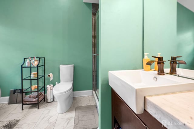 full bathroom featuring marble look tiles, toilet, a shower with door, and baseboards