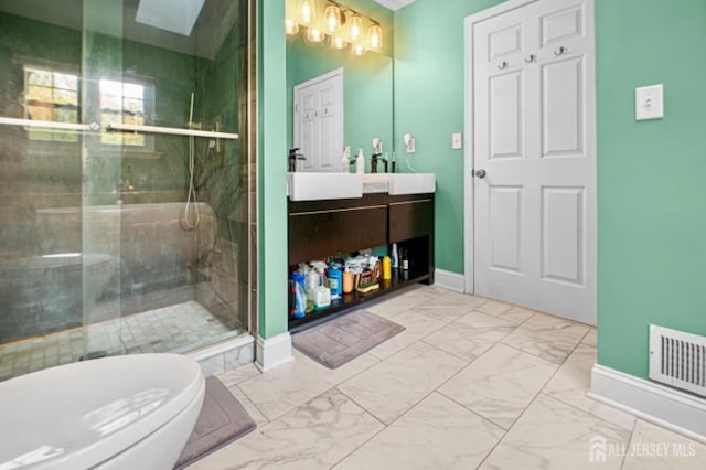 full bathroom featuring baseboards, marble finish flooring, a stall shower, and vanity