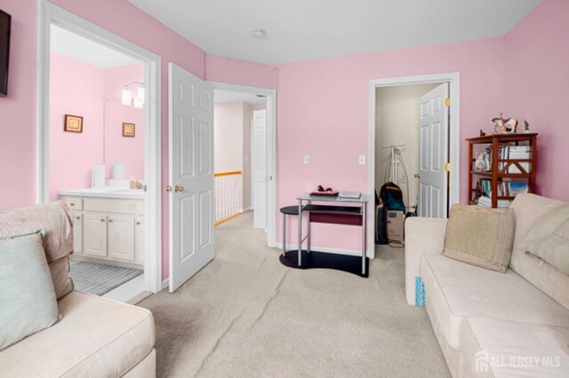 living area with light colored carpet and baseboards