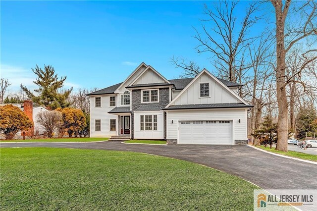 view of front of house featuring a garage and a front lawn