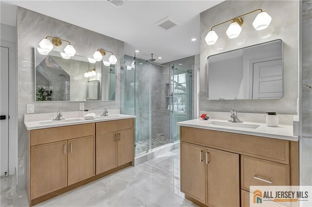 bathroom featuring vanity and a shower with shower door