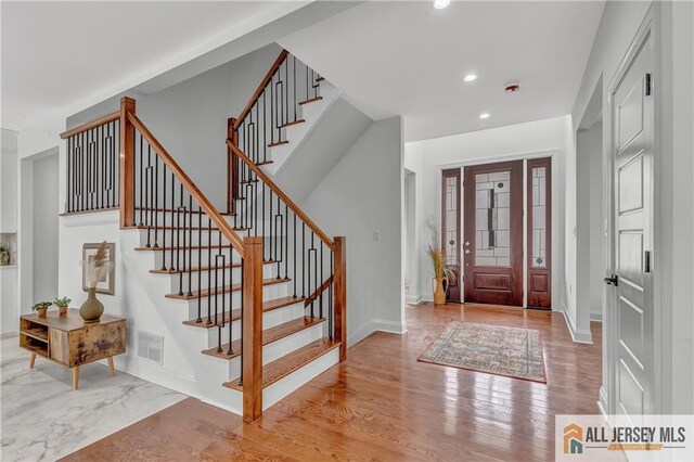 foyer entrance with light hardwood / wood-style flooring