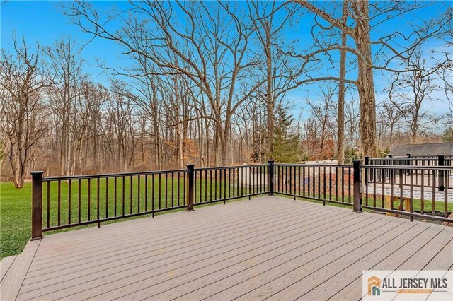 wooden deck with a lawn