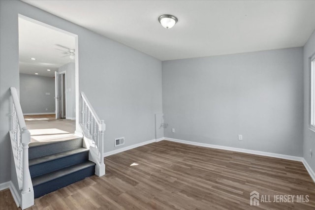 unfurnished room with dark wood-type flooring