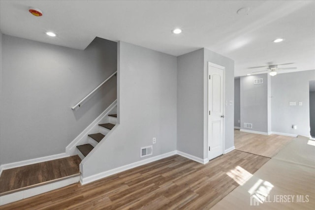 interior space with wood-type flooring and ceiling fan