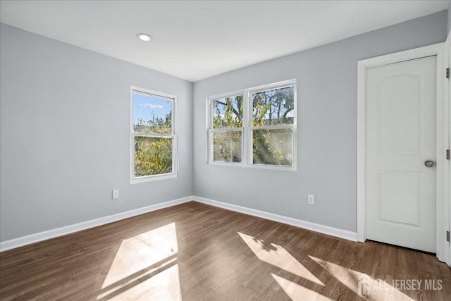 spare room featuring dark wood-type flooring