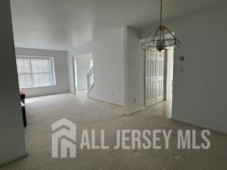284 Brookfield Dr, Jackson, NJ 08527 - unfurnished dining area featuring a chandelier and carpet flooring