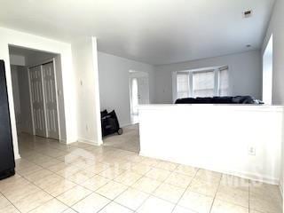 284 Brookfield Dr, Jackson, NJ 08527 - unfurnished living room with light tile patterned flooring and baseboards