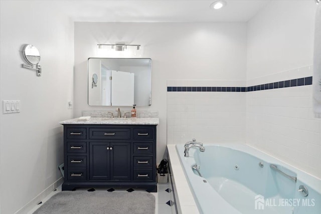 675 Raritan Rd, Clark, NJ 07066 - full bathroom featuring vanity, a whirlpool tub, and baseboards