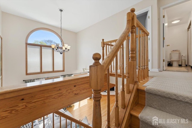 675 Raritan Rd, Clark, NJ 07066 - stairs featuring a chandelier, wood finished floors, and baseboards