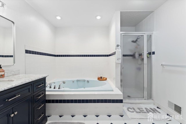 675 Raritan Rd, Clark, NJ 07066 - full bathroom with vanity, a jetted tub, and a shower stall