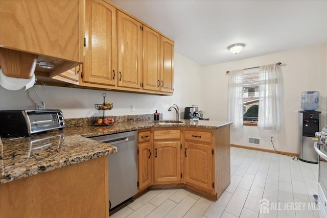 675 Raritan Rd, Clark, NJ 07066 - kitchen featuring dishwasher, a peninsula, a sink, dark stone counters, and baseboards