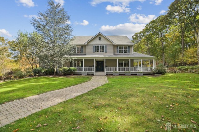 farmhouse with a porch and a front lawn