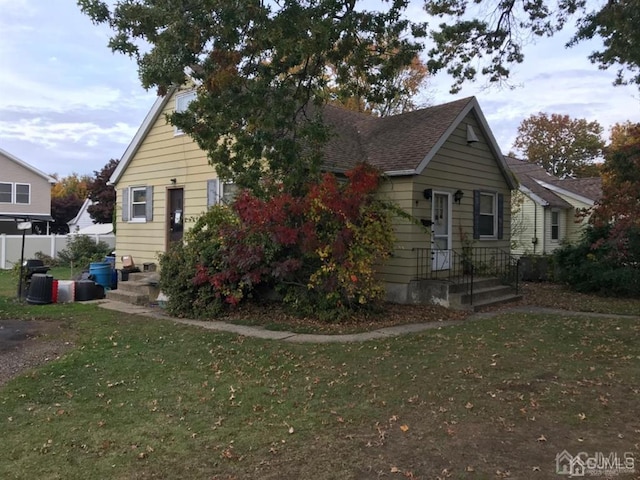 bungalow-style house featuring a front yard