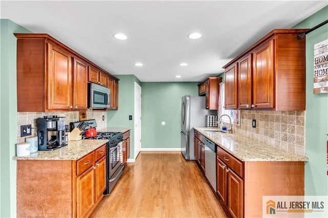 11 Donna St, East Brunswick, NJ 08816 - kitchen featuring appliances with stainless steel finishes, light wood finished floors, backsplash, recessed lighting, and light stone countertops