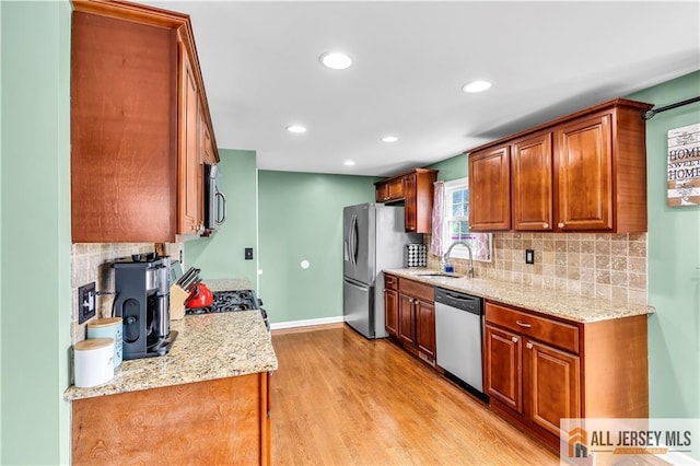 11 Donna St, East Brunswick, NJ 08816 - kitchen with appliances with stainless steel finishes, light wood-style floors, decorative backsplash, recessed lighting, and light stone countertops