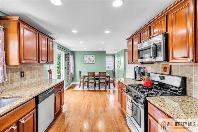 11 Donna St, East Brunswick, NJ 08816 - kitchen with stainless steel appliances, light wood finished floors, recessed lighting, light stone counters, and backsplash