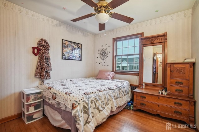 42 Frederick St, Carteret, NJ 07008 - bedroom featuring a ceiling fan, wallpapered walls, and hardwood / wood-style floors