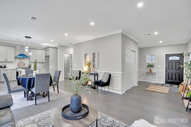 living room featuring ornamental molding and light wood-type flooring