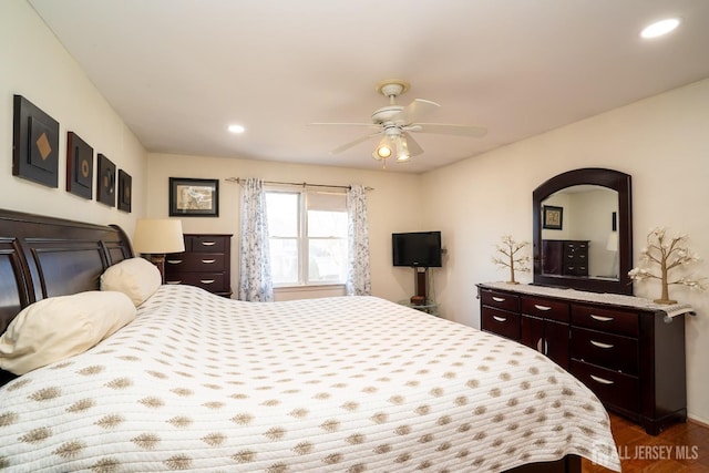 bedroom with ceiling fan and dark wood-type flooring