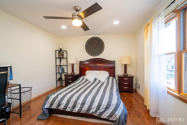 bedroom with ceiling fan and dark hardwood / wood-style flooring