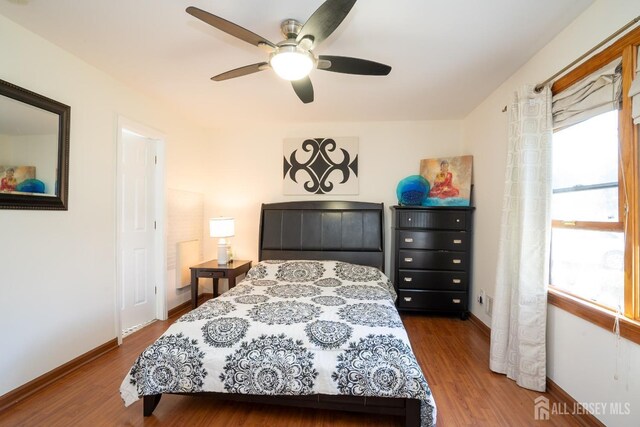 bedroom with hardwood / wood-style flooring and ceiling fan