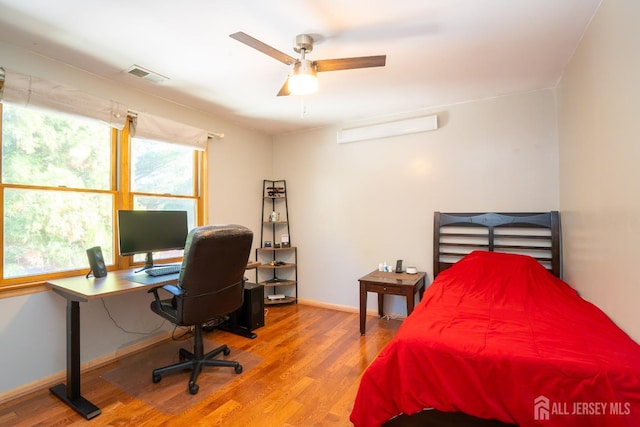 bedroom with hardwood / wood-style flooring and ceiling fan