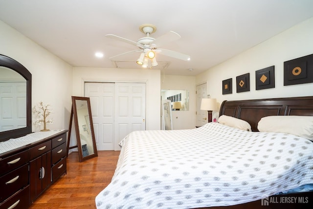 bedroom with ceiling fan and dark hardwood / wood-style flooring