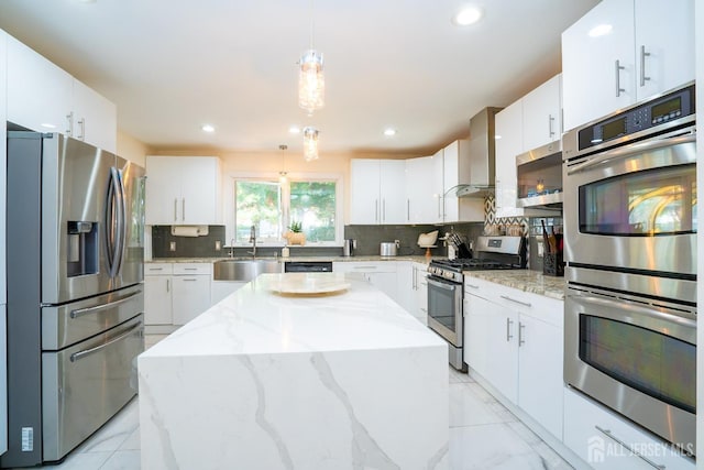 kitchen featuring a center island, white cabinets, stainless steel appliances, and sink