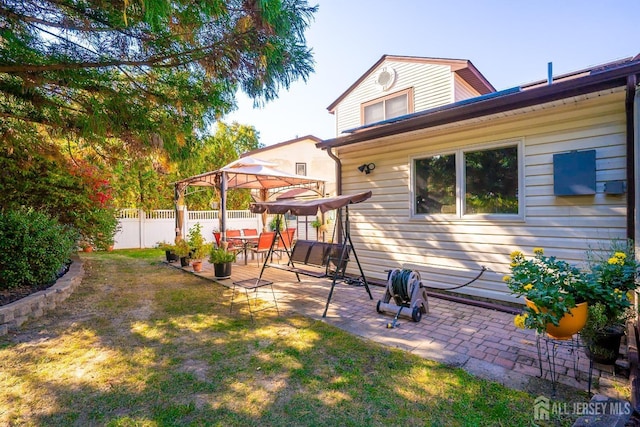 back of house featuring a lawn, a patio area, and a gazebo