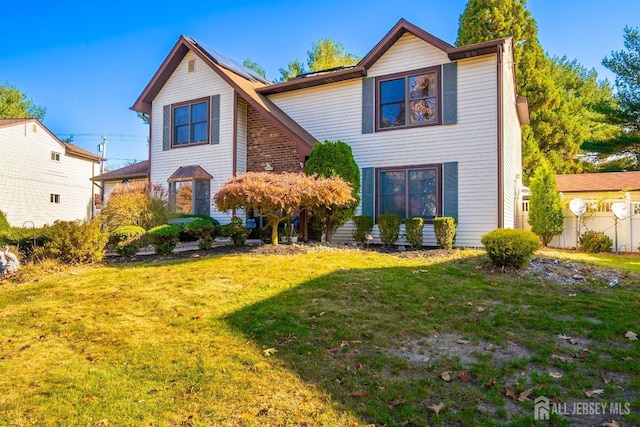 front facade featuring a front yard