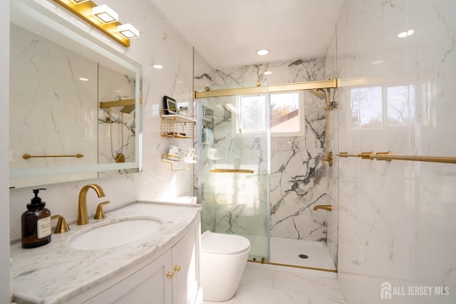 bathroom featuring vanity, toilet, and a shower with door